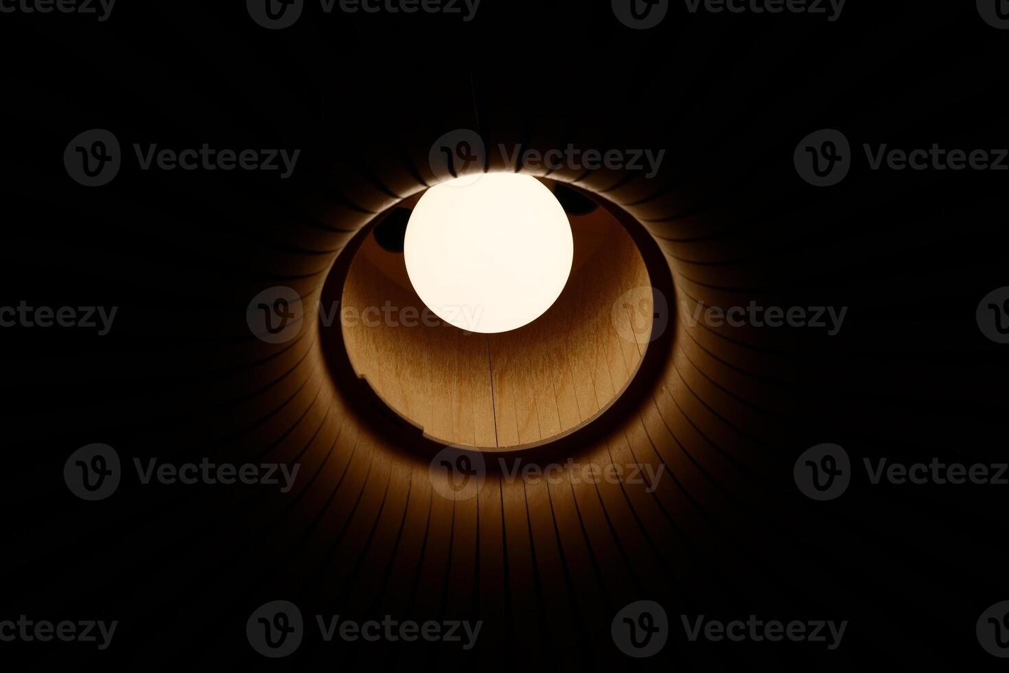 A Beautifully Illuminated Circular Opening Creating a Contrast in an Expansive Dark Space photo