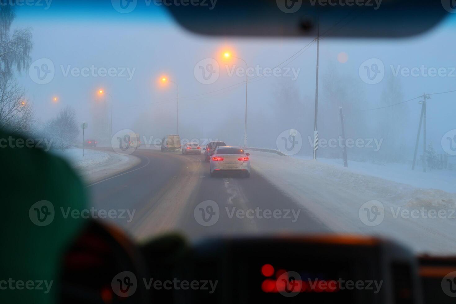 A Foggy Winter Drive Engaging Evening Commute in Challenging Snowy Conditions Ahead photo