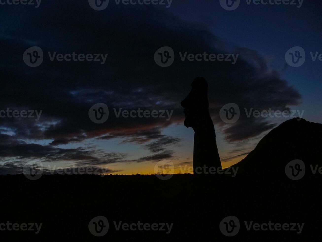 Statues of Easter Island in the background of the sunset. melting of the Easter statue in the sunlight of the sunset. photo