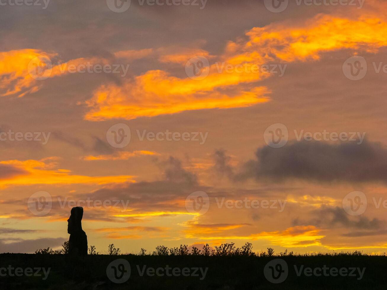 Statues of Easter Island in the background of the sunset. melting of the Easter statue in the sunlight of the sunset. photo