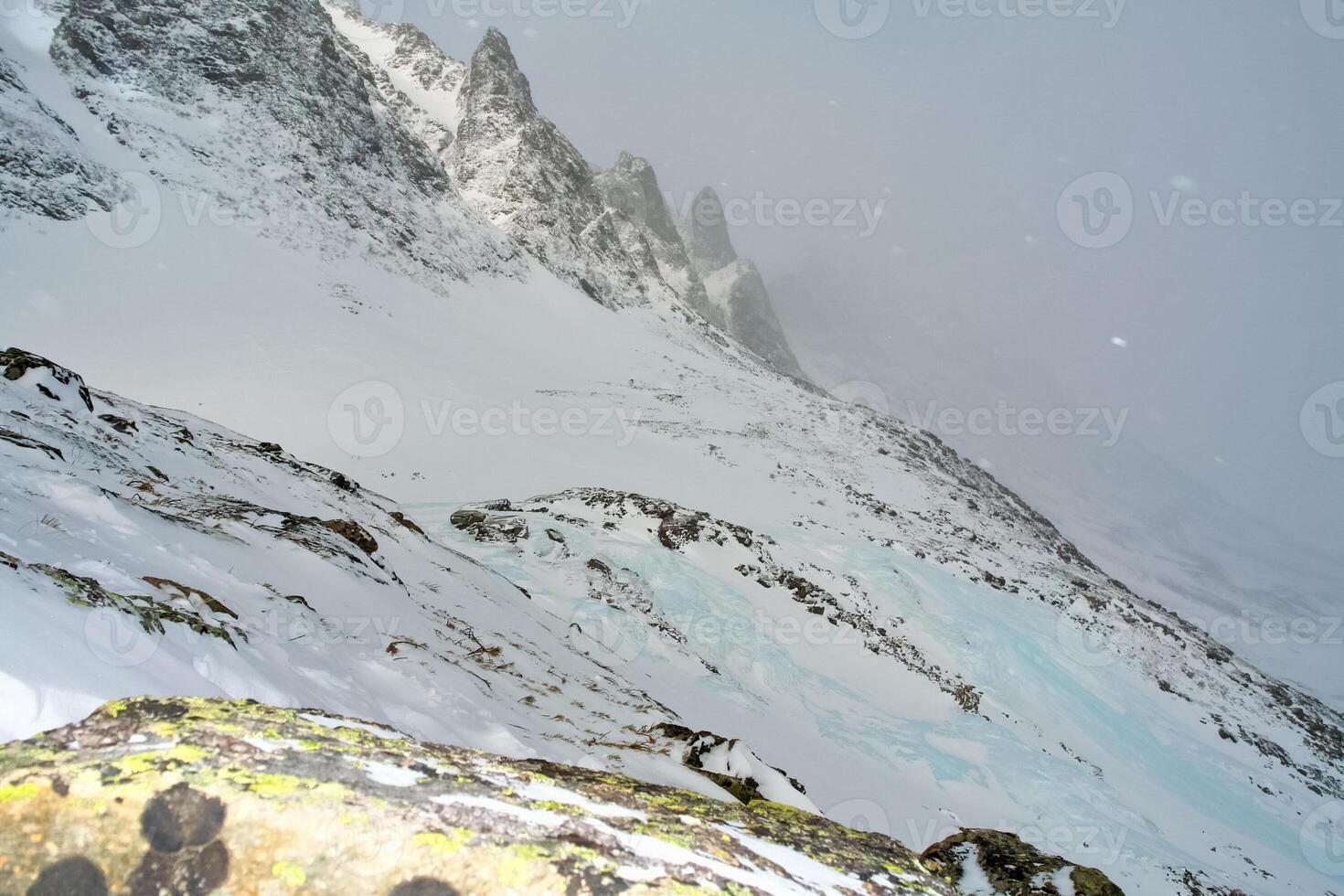 Baikal mountains in winter in snow. Forest in snow covered mountains. photo