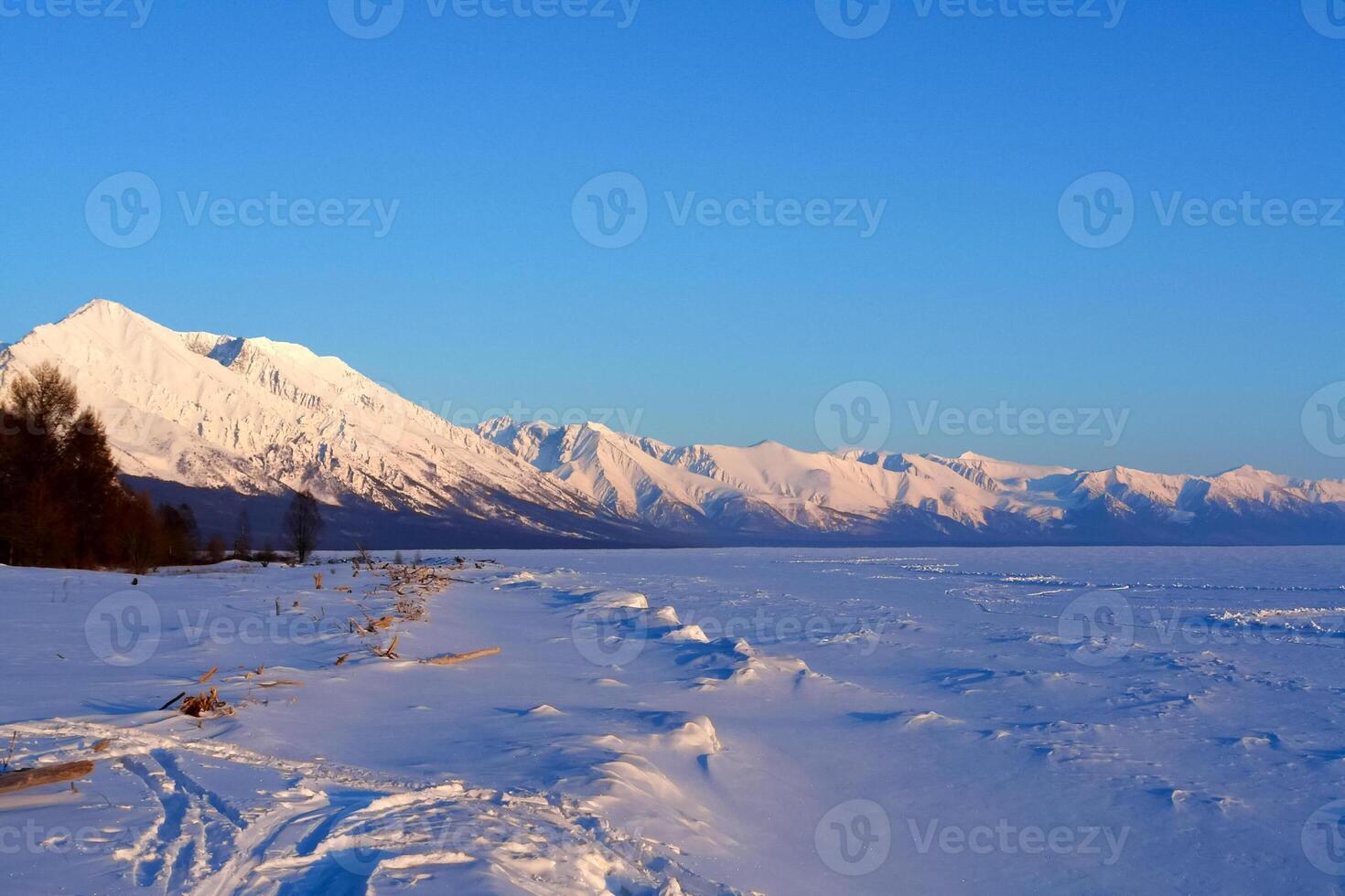 winter landscape of Lake Baikal. Beautiful mountains in the snow and sky photo