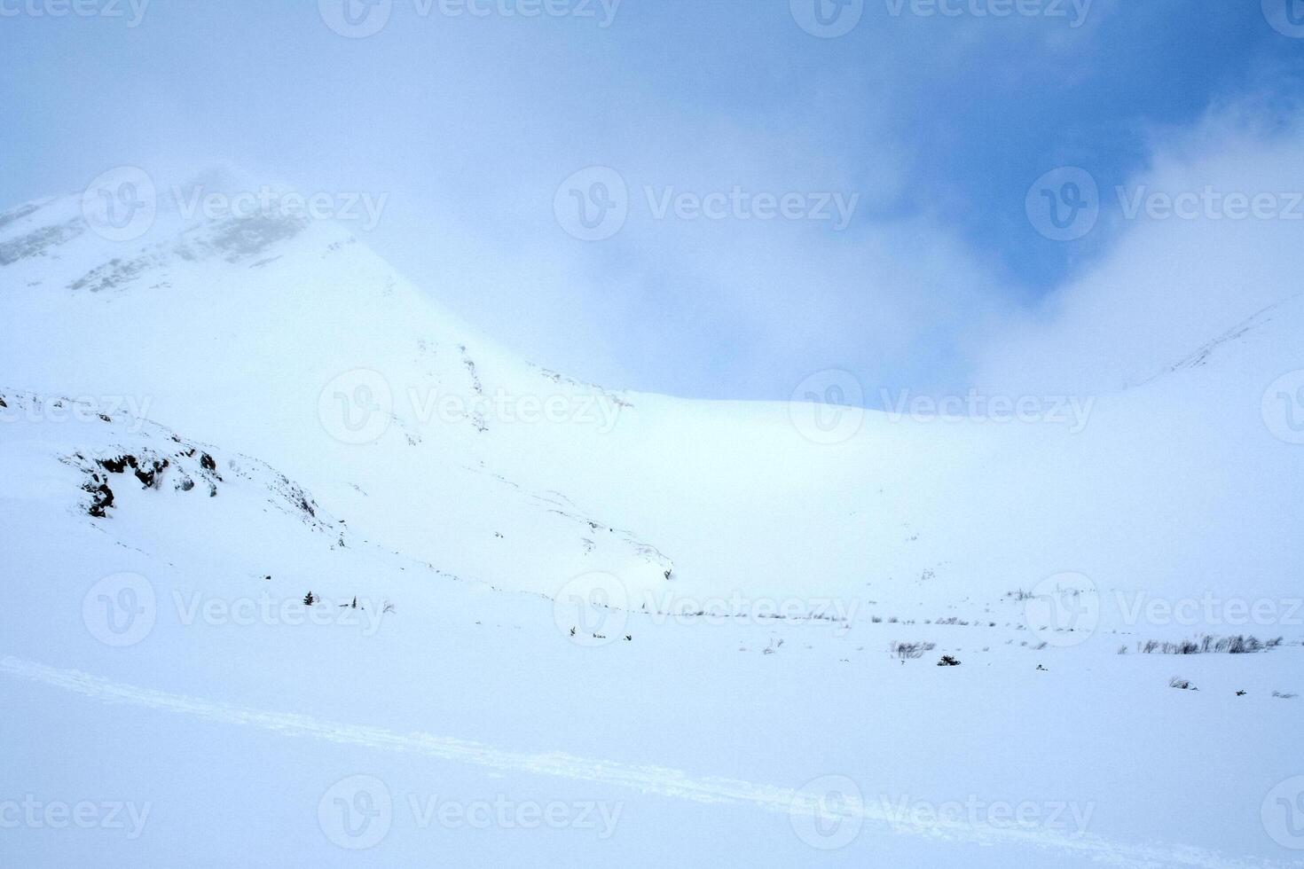 Baikal mountains in winter in snow. Forest in snow covered mountains. photo