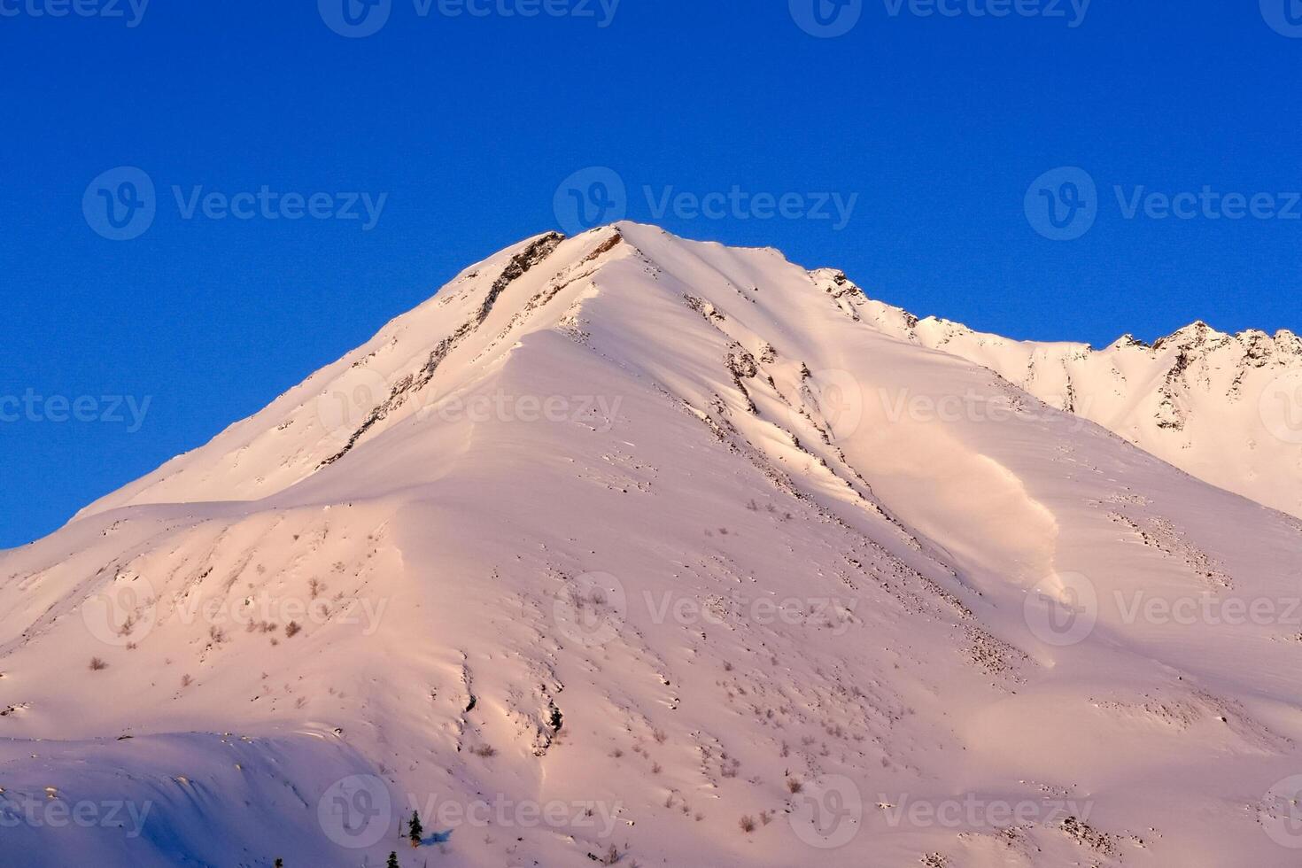 Baikal mountains in winter in snow. Forest in snow covered mountains. photo