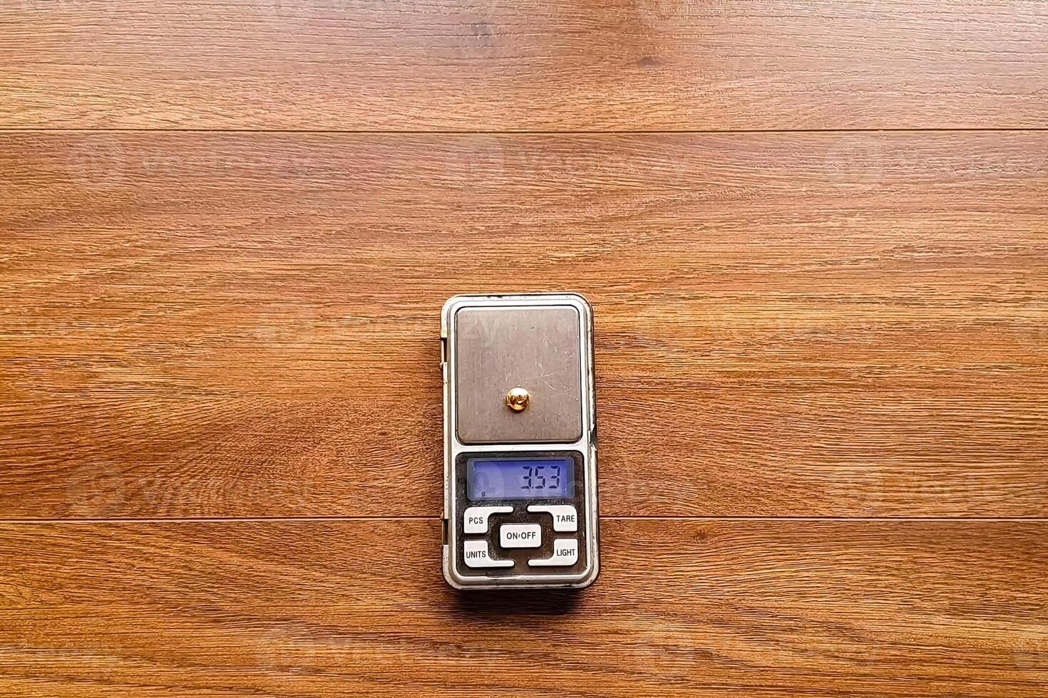small piece of gold on an electronic scale. photo