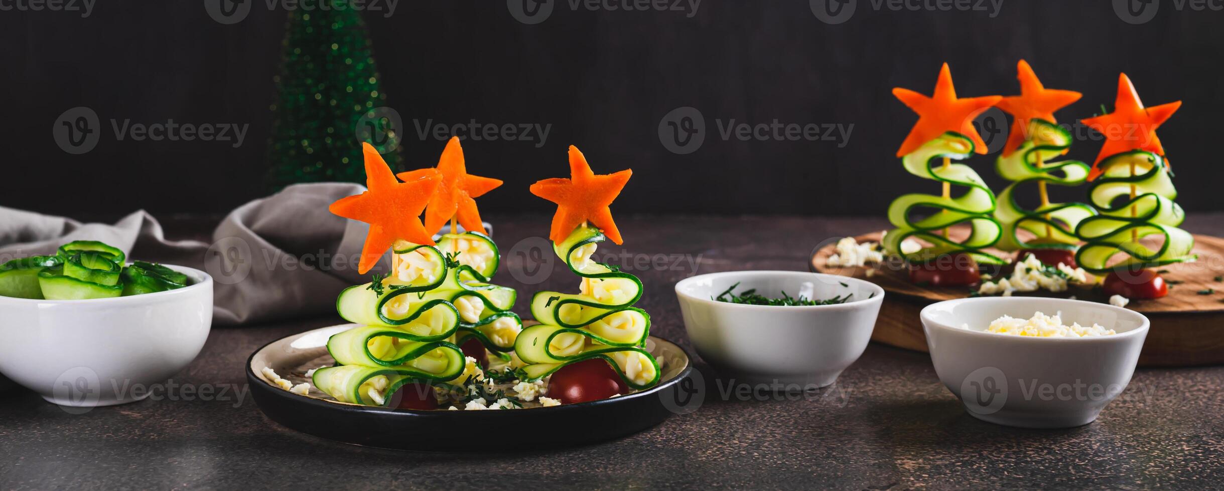 Snack trees made of cucumbers, tomatoes and cheese on a plate on the table web banner photo