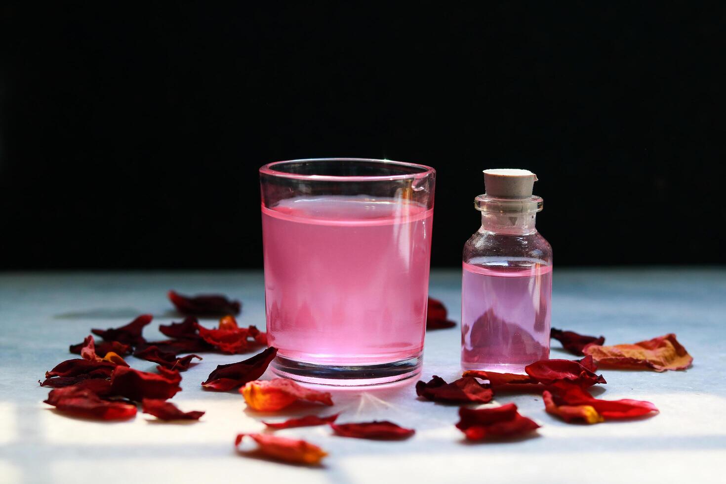 Candle rose petals, and rose water, Spa and wellness setting photo