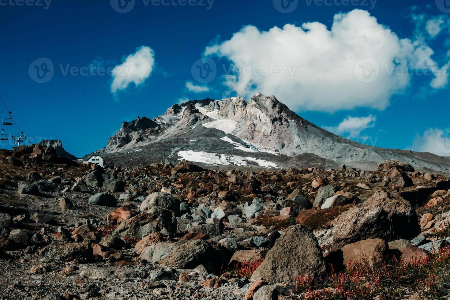 A mountain with rocks and a blue sky photo