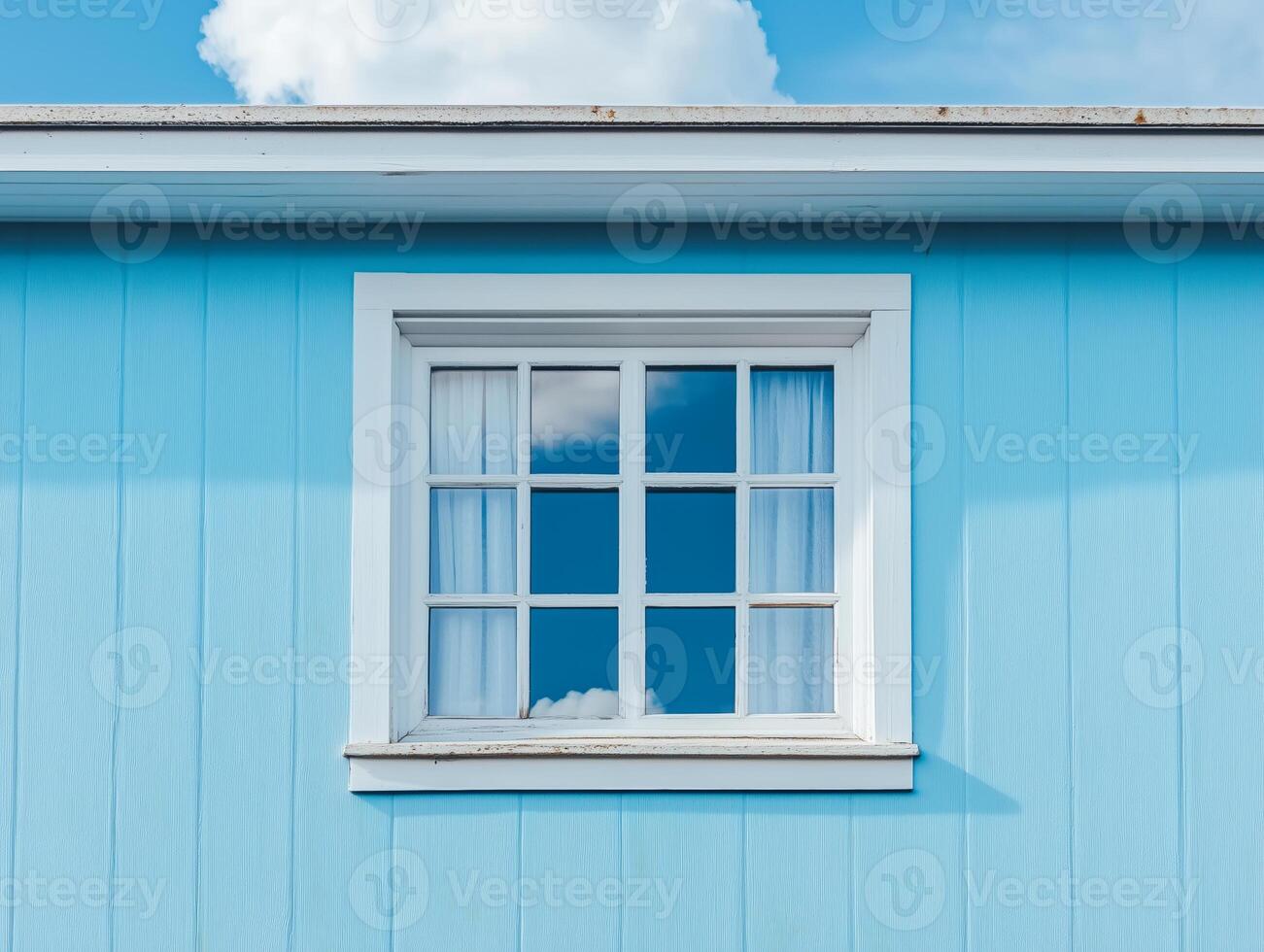A blue house with a window and a white sky photo