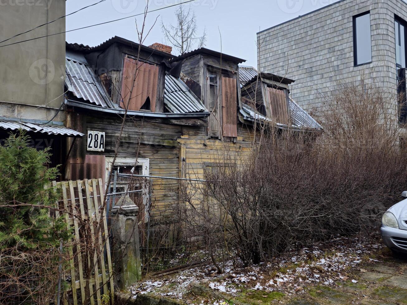 an old house with a car parked in front of it photo