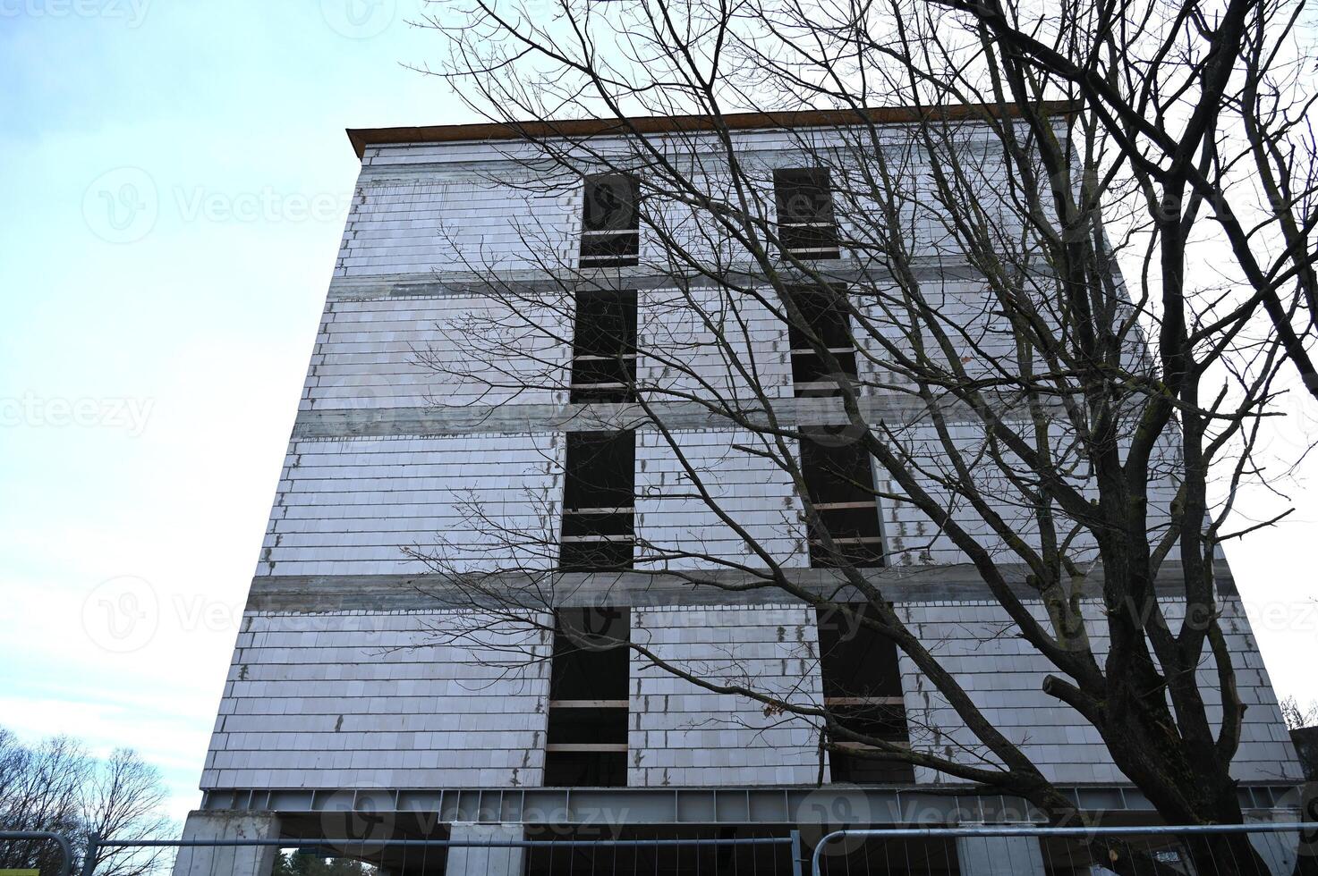a tall building with a tree in front of it photo