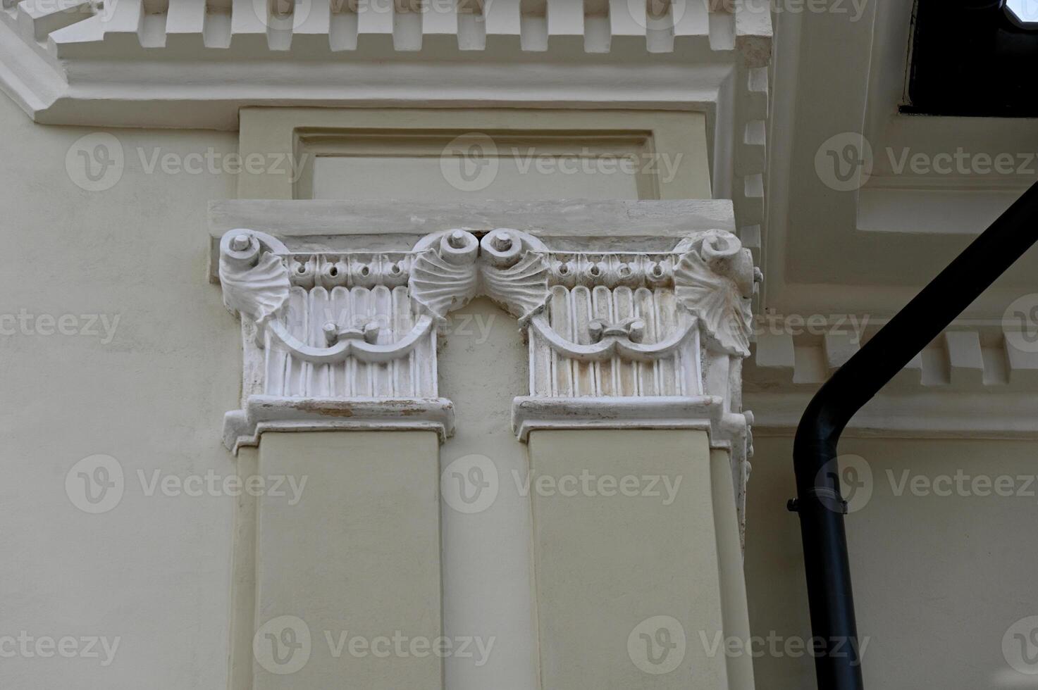 a white column with decorative designs on it photo