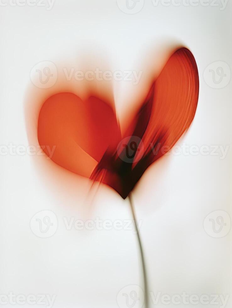 A blurred, Red heart-shaped red flower in motion against a white background photo