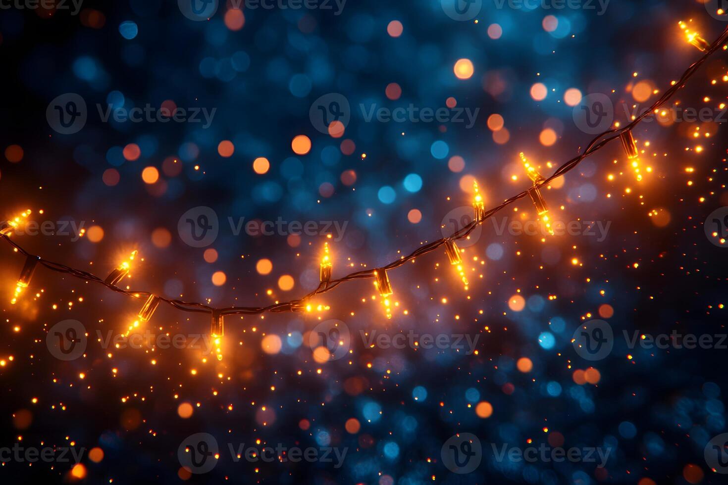 Festive String Lights Against a Blue Bokeh Background for Holiday Decor and Celebration Designs photo