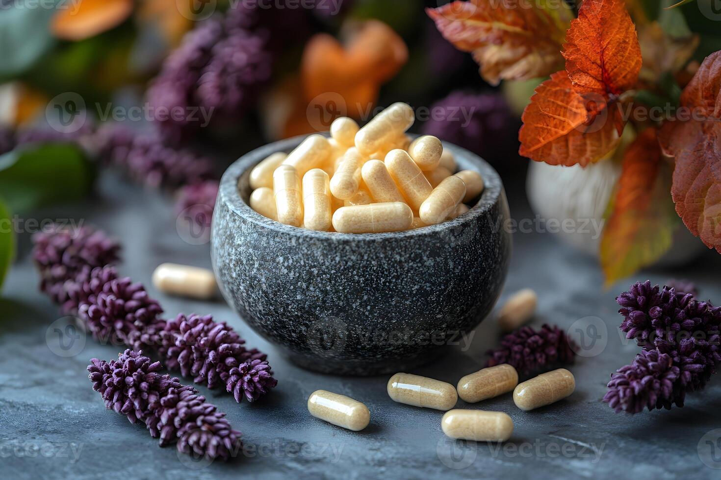 Herbal Capsules in Stone Bowl with Autumn Leaves and Purple Flowers for Natural Health and Wellness Promotion photo
