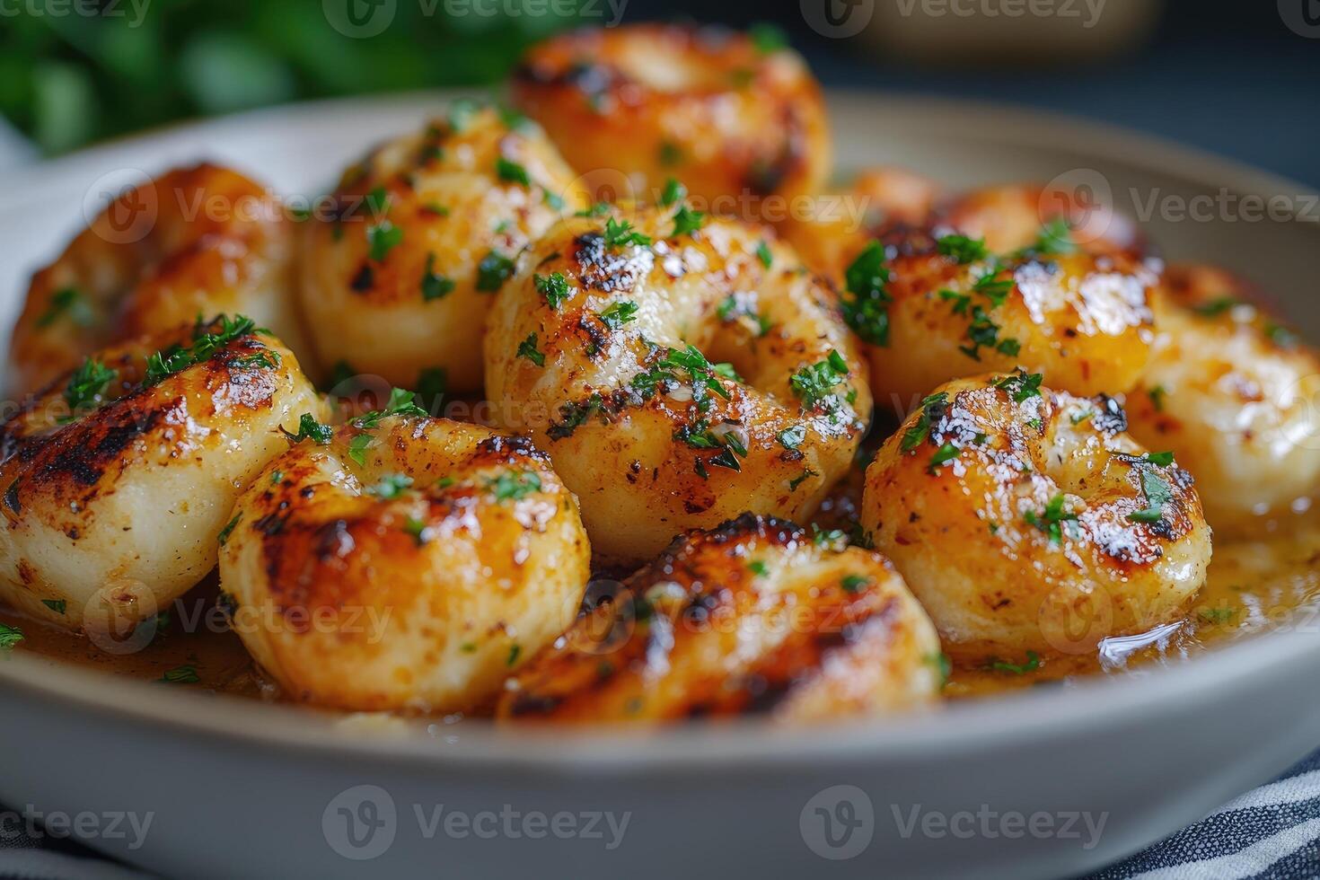 Delicious roasted scallops with butter and parsley lying in a bowl photo