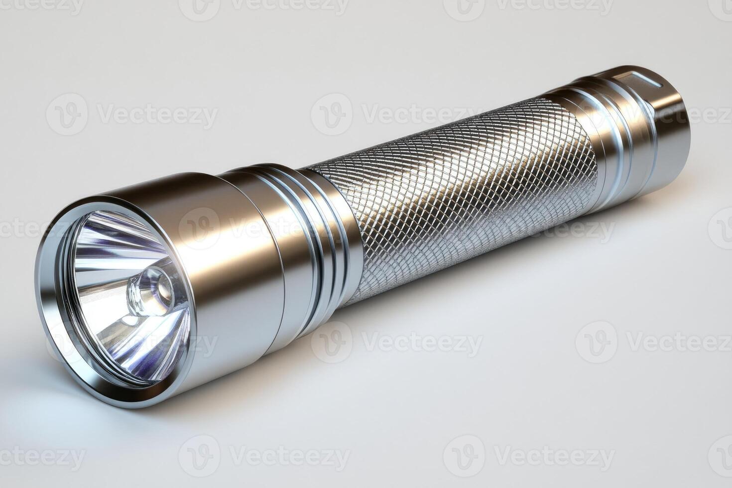 Chrome metal flashlight resting on white background photo