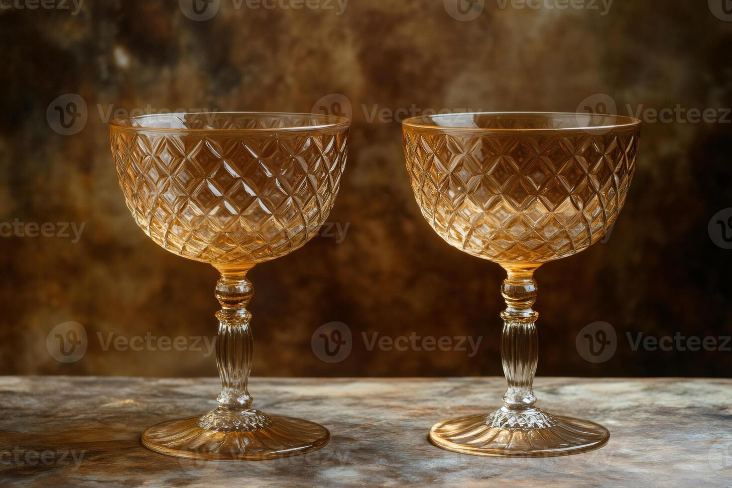 Two elegant coupe glasses resting on rustic wooden surface photo
