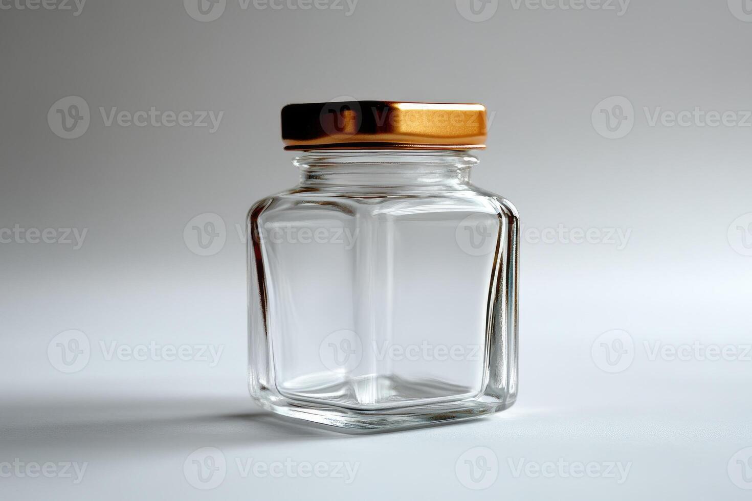 Empty square glass jar with golden lid on white background photo