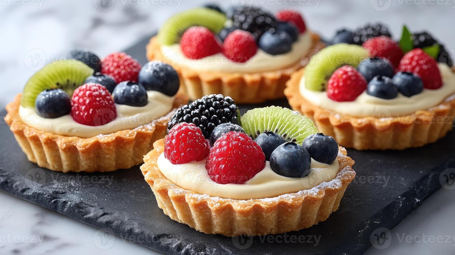Delicious fruit tarts displayed on marble surface, freshly baked and ready to eat photo