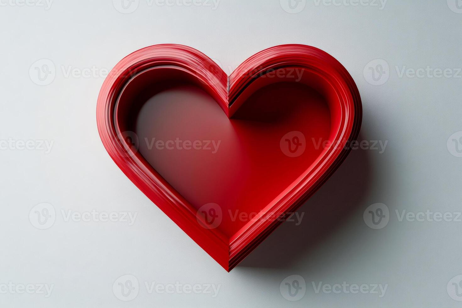 Red heart shape emerging from concentric layers on white background photo
