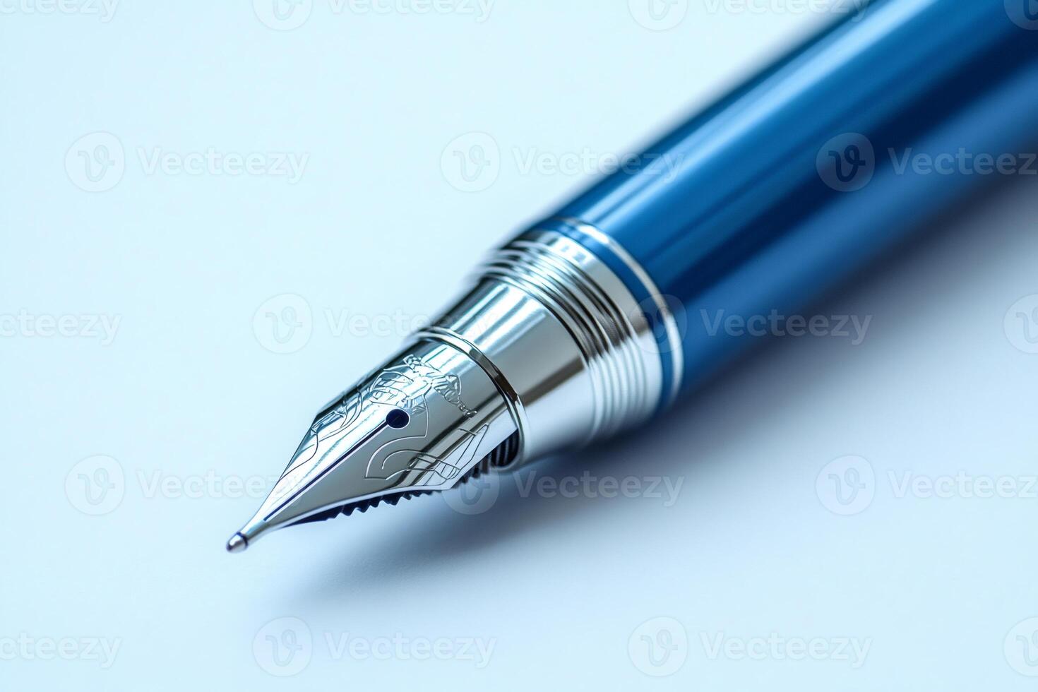 Close-up of elegant blue fountain pen nib resting on white surface photo