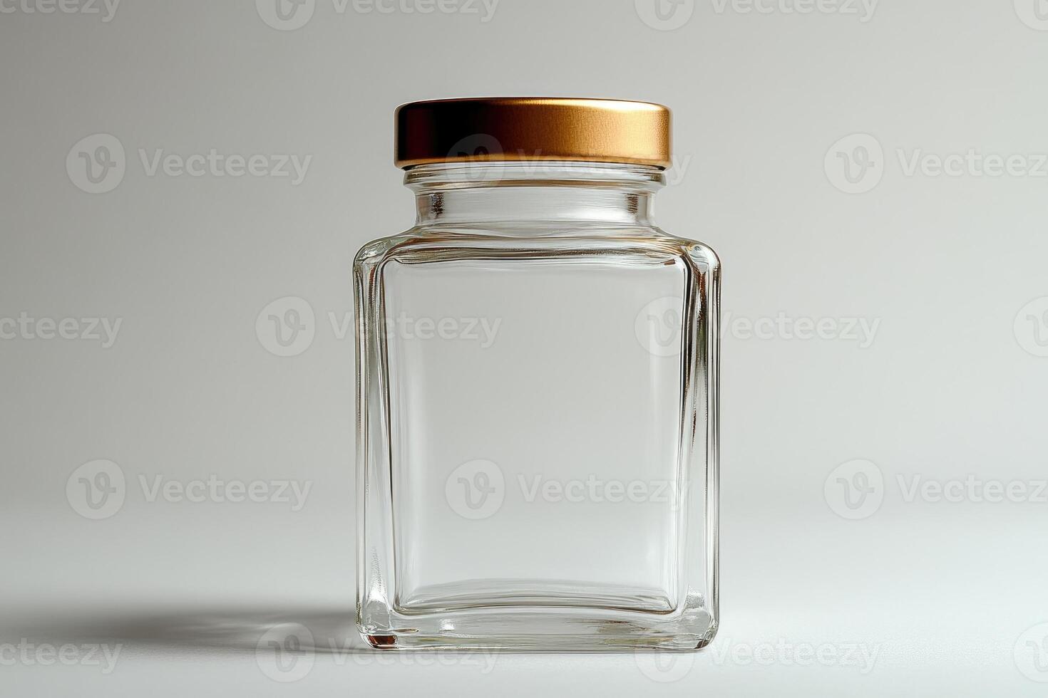 Empty square glass jar with gold lid on white background photo