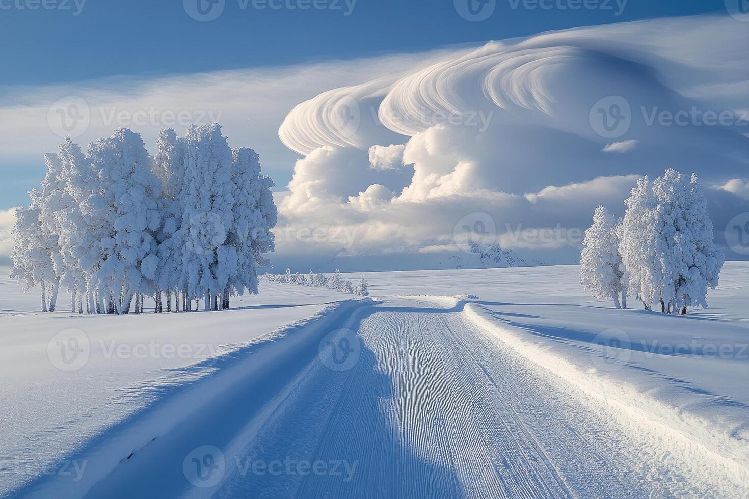 Snowy road leading through frosted trees and rolling hills under a lenticular cloud formation photo