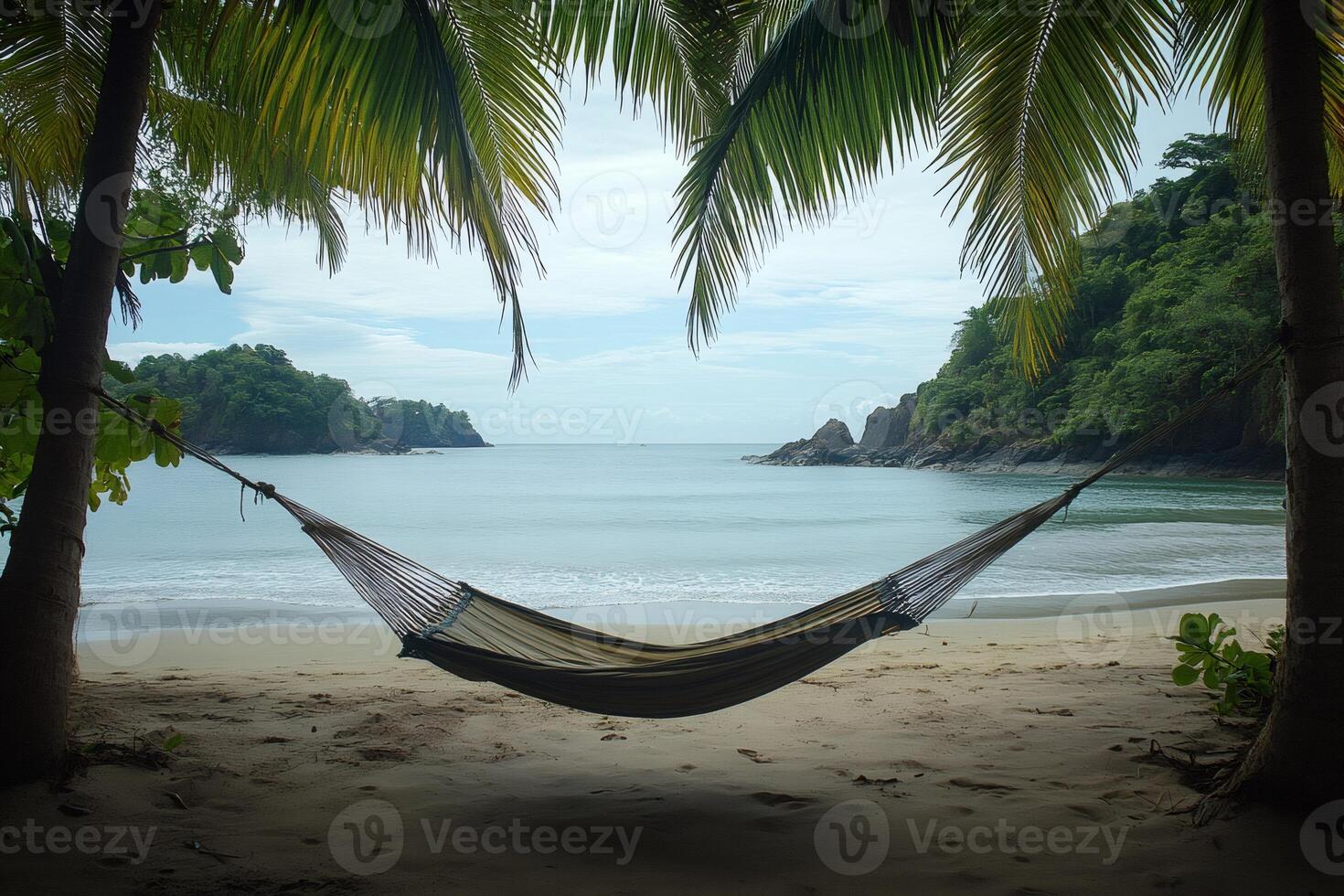 Hammock relaxing on tropical beach with palm trees and turquoise water photo