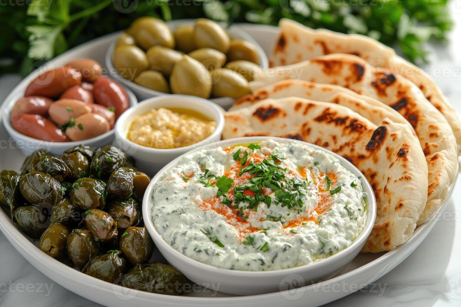 Spinach and feta dip sharing platter with pita bread and olives photo