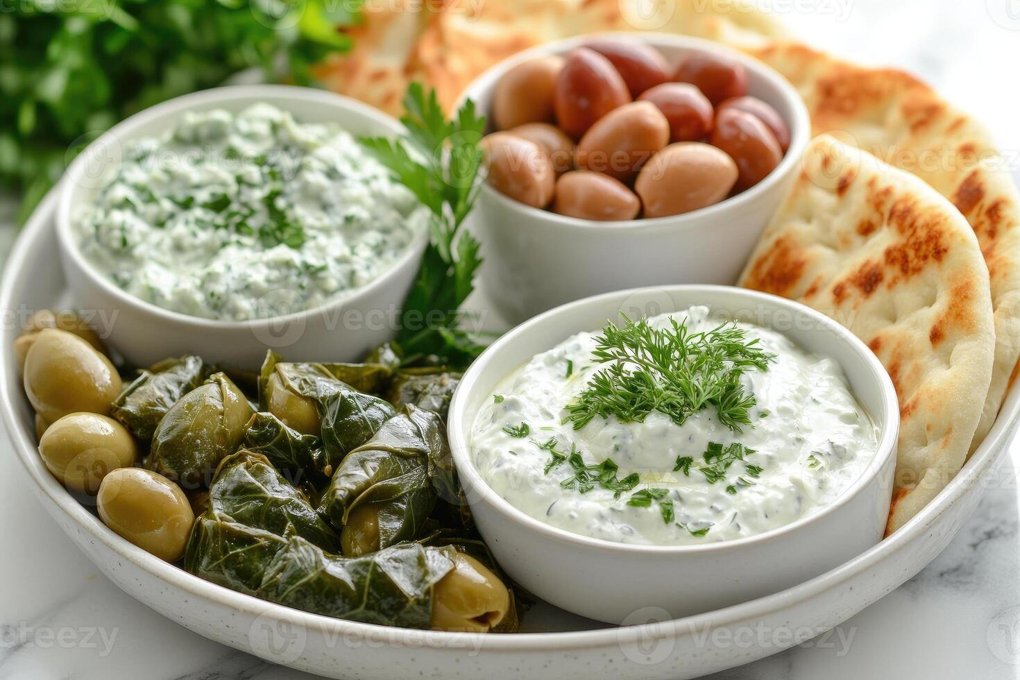 Spinach and feta dip sharing platter with pita bread and olives photo