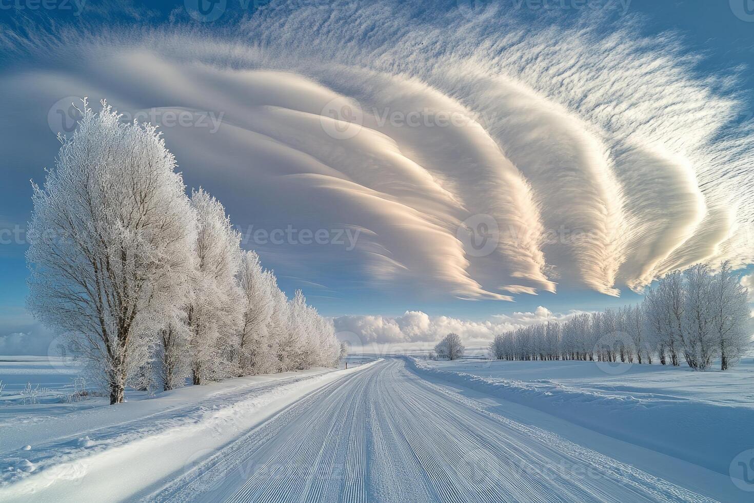 Stunning lenticular clouds hovering over a snowy road and frosted trees photo