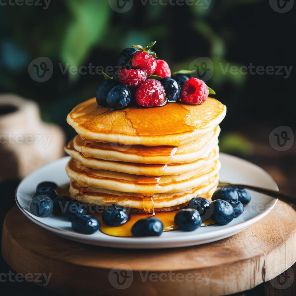 Delicious stack of pancakes topped with fresh berries and maple syrup on a wooden table photo