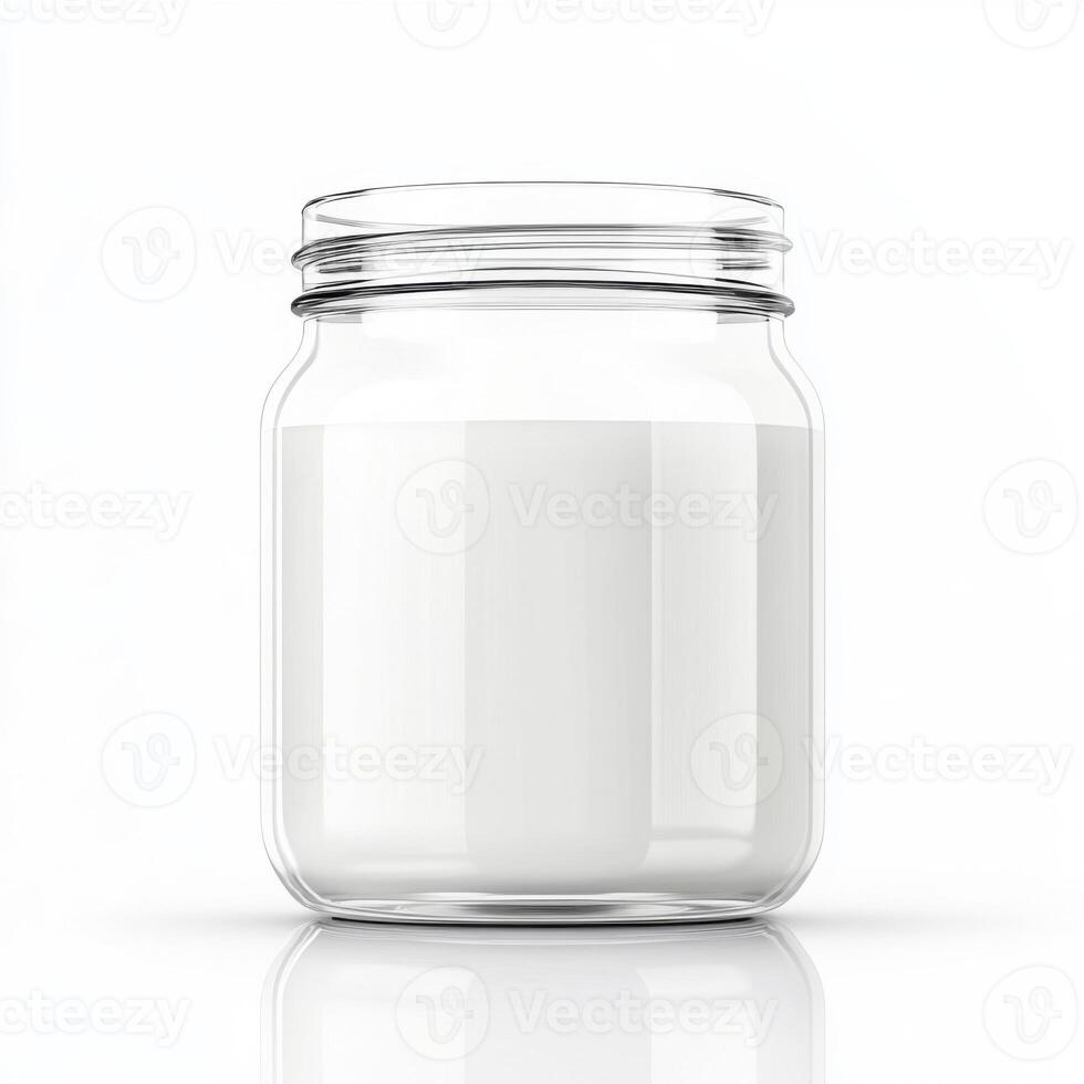 Glass jar filled with fresh milk sits on a clean white surface in a bright kitchen photo