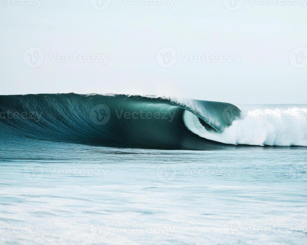 Majestic ocean wave curling gracefully at sunrise along a tranquil shoreline with soft waves in the background photo