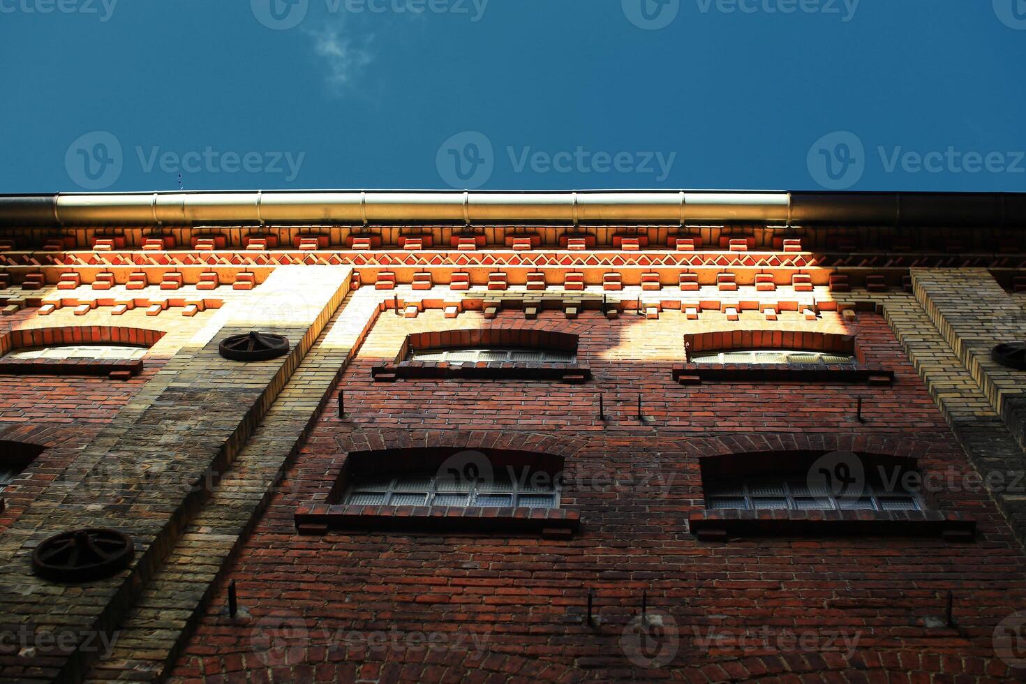 Upward view on facade of old factory building photo