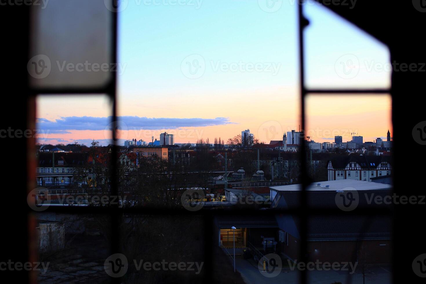 View through ruined window with missing panes in the middle of the city of Magdeburg, Germany photo