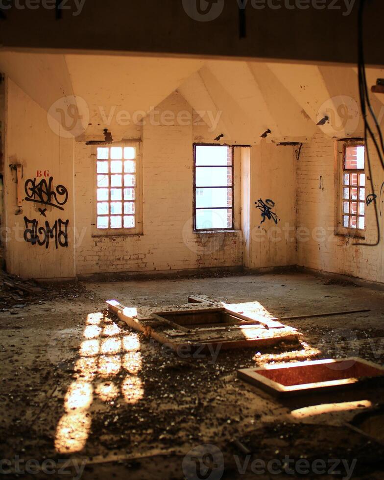 Abandoned silo interior with debris and bright sunlight photo