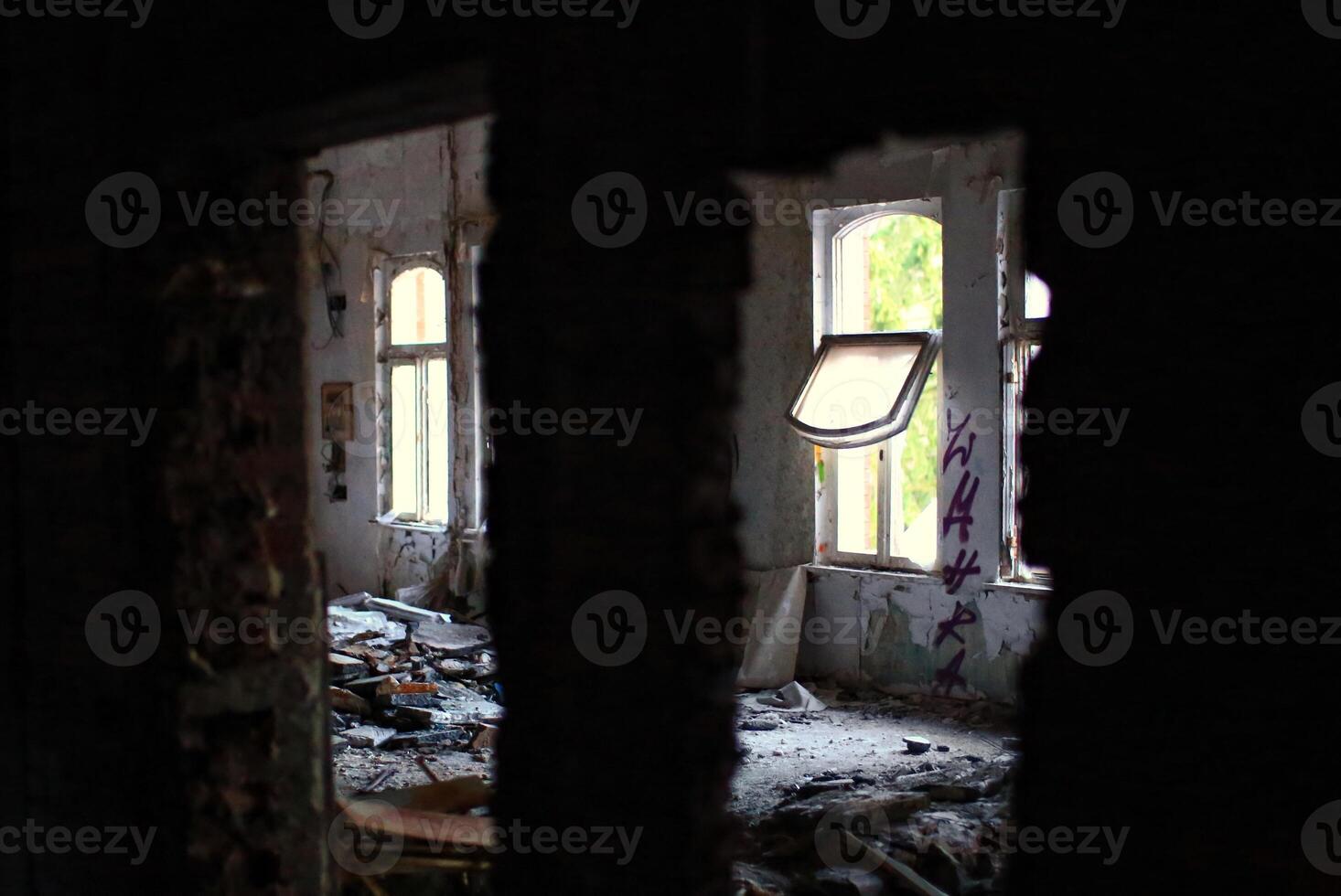 Abandoned room filled with debris and an open window photo