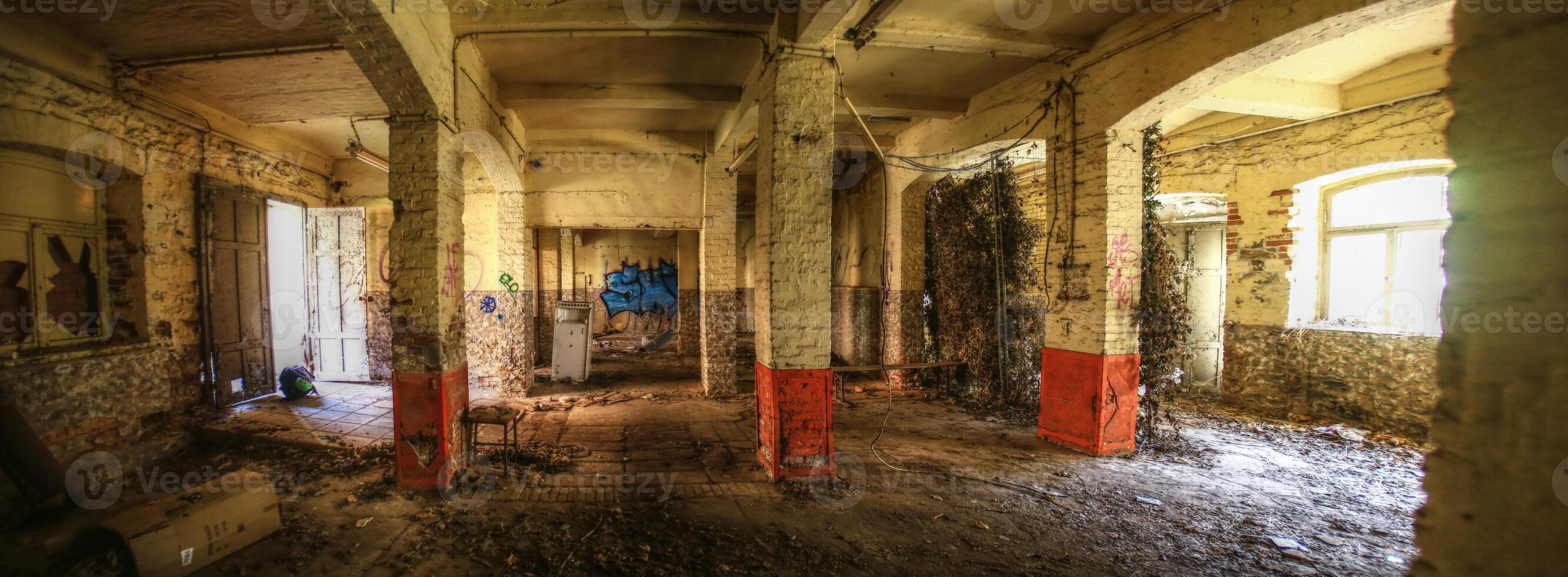 Interior of an abandoned storage building with gate and window photo