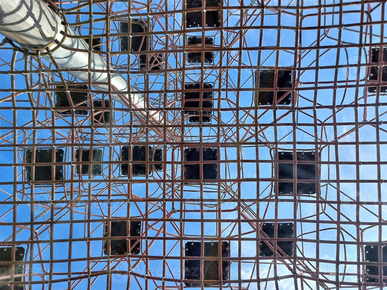 Upward view through the safety net of a climbing playground photo