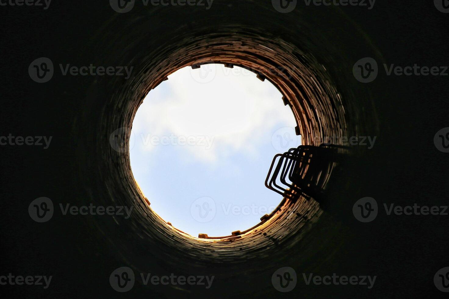Upward view from inside of an old chimney photo