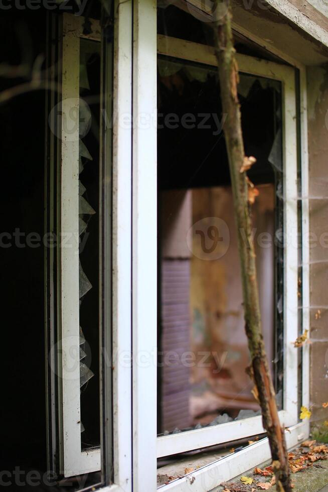 Broken and open window with glass shards photo