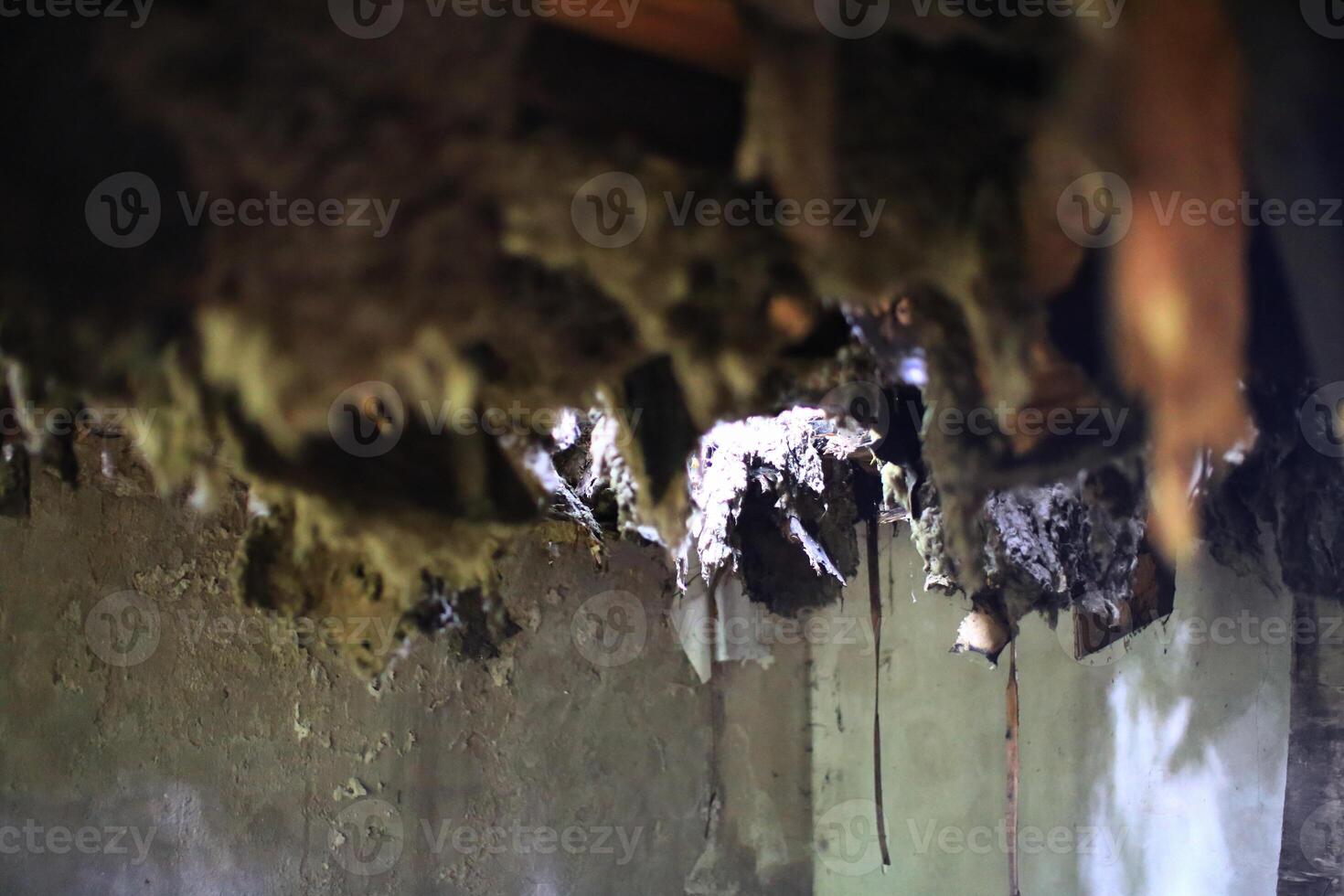 Ceiling in an abandoned building falling down creating a hole photo
