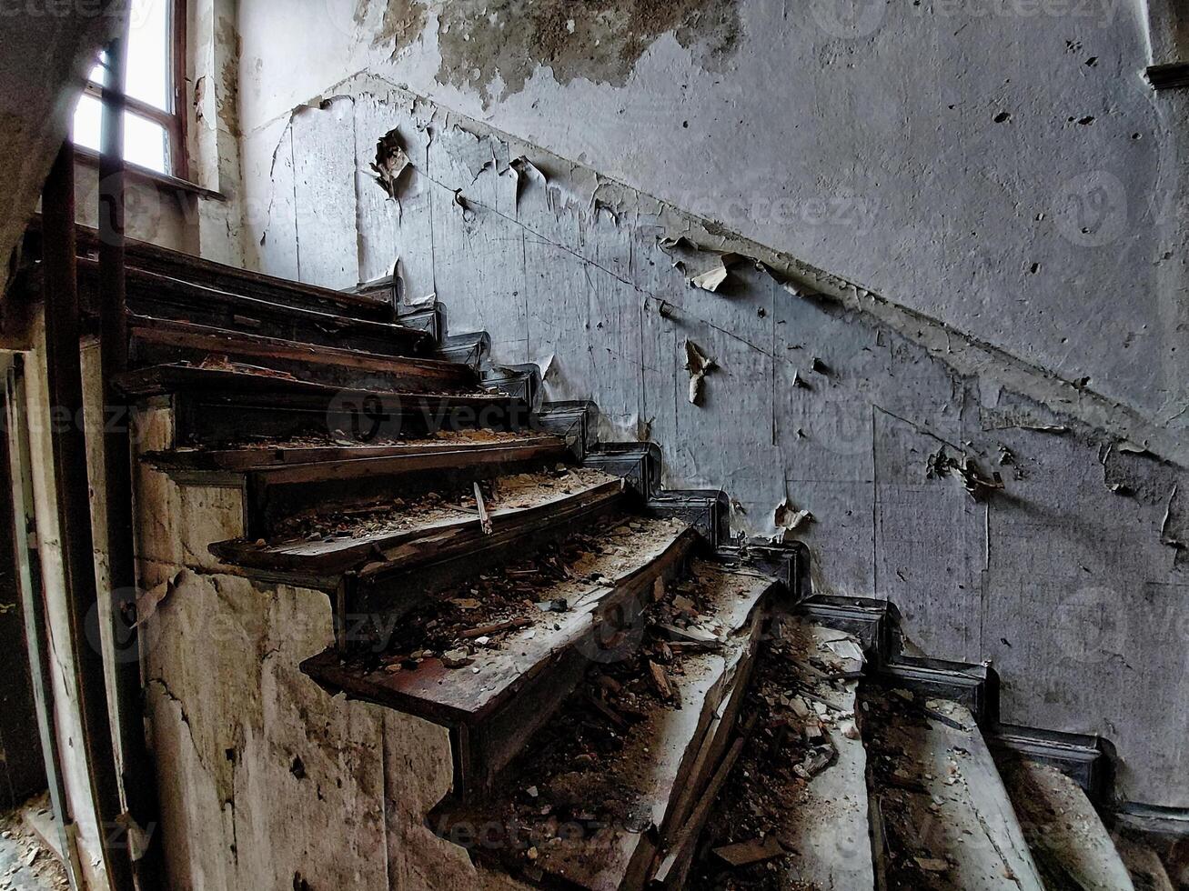 Noisy image of desolate staircase in an abandoned building photo