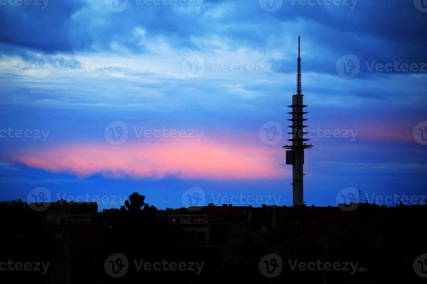 Dramatic evening cloudscape over Hannover with silhouette of the radio tower Telemax photo