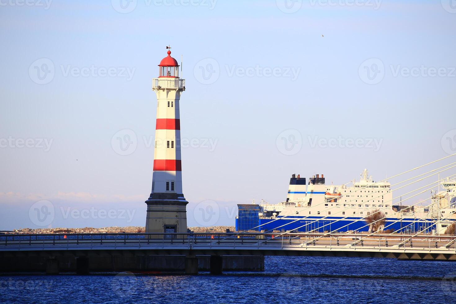 Lighthouse, bridge and ferry at harbor of Malmo in Sweden photo