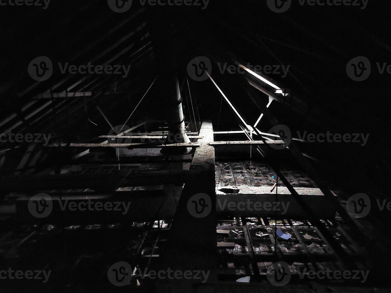 Dark and creepy attic with little daylight photo