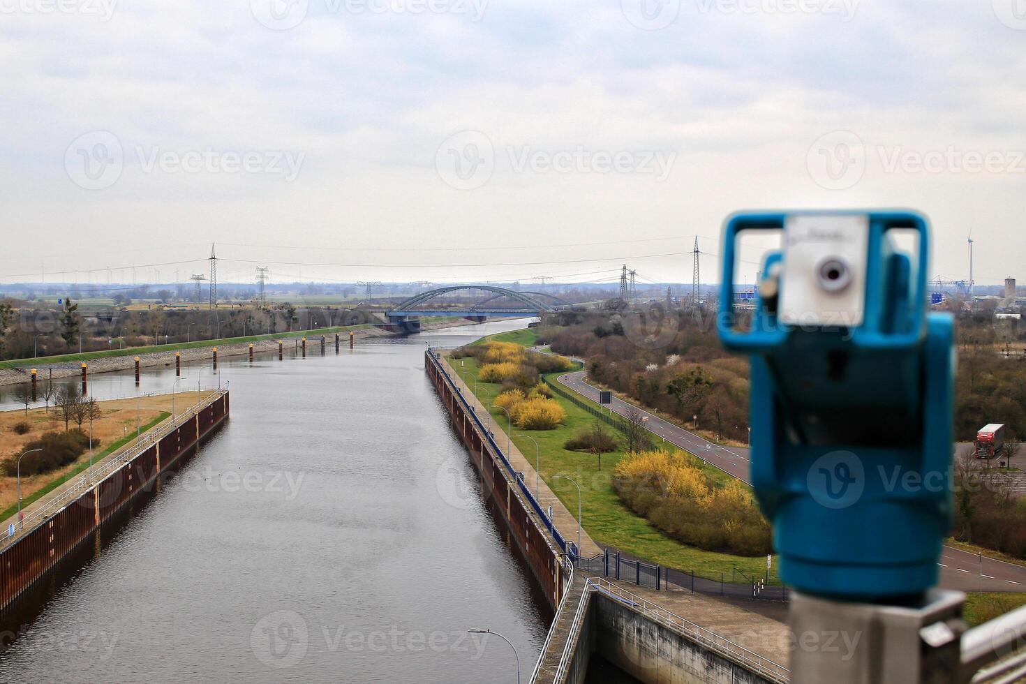 View over canals near Magdeburg with coin-operated binoculars in blurred foreground photo