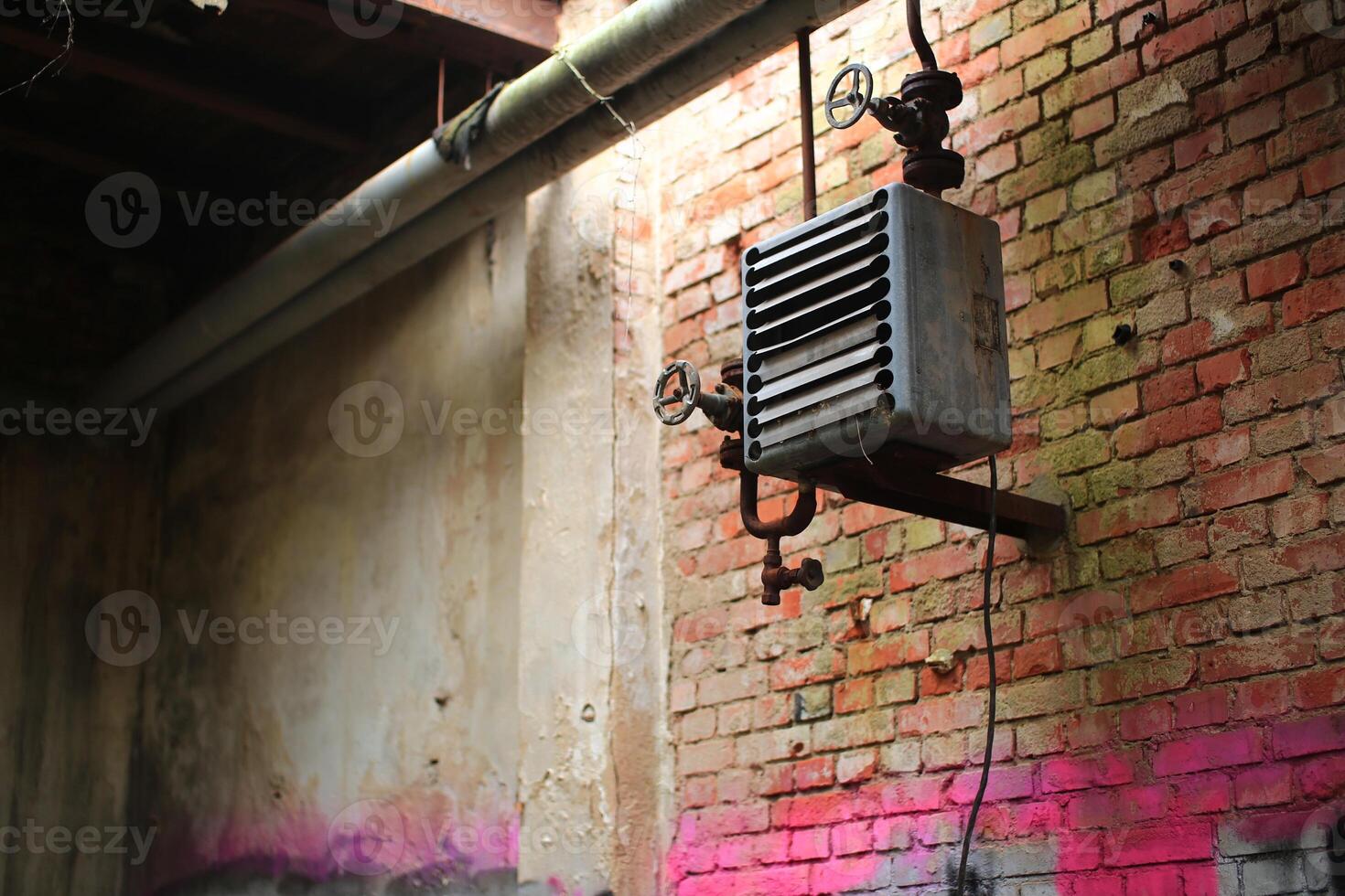 Rusty heating system in an abandoned factory building photo